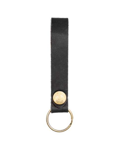 The Homestead Brand Standard Key Fob No. 1603 is made from USA-tanned leather and features solid brass hardware, including a key ring and a small engraved oval plate near the ring.