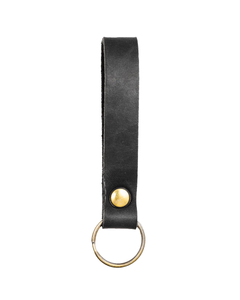 The Homestead Brand Standard Key Fob No. 1603 is crafted from USA-tanned leather with solid brass hardware, a black leather loop, brass button, and sturdy metal keyring—elegantly shown on a white background.