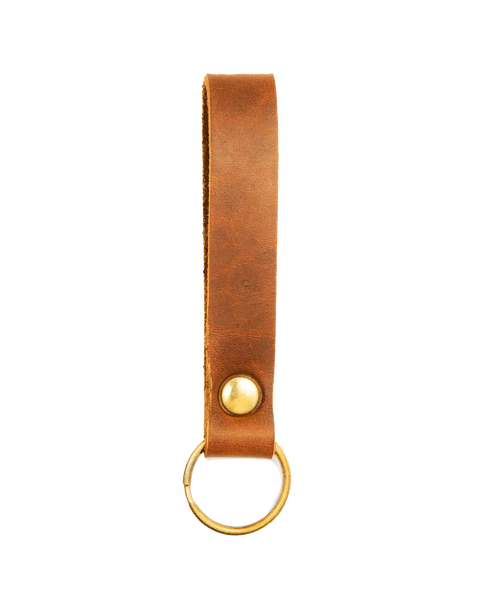 The Homestead Brand Standard Key Fob No. 1603 is made from USA-tanned brown leather with a solid brass snap fastener and round key ring, shown on a white background.