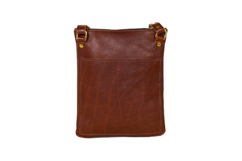 The Urban Southern Urban Slim Crossbody is a brown leather bag with gold hardware, a front pocket, and zipper closure, shown against a white background—ideal as a lightweight urban handbag for everyday use.