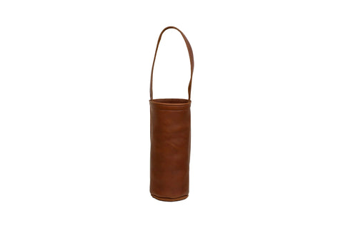 The Urban Southern Urban Wine Tote is a cylindrical brown leather wine carrier with a single handle, handcrafted in the USA and displayed upright against a white background.