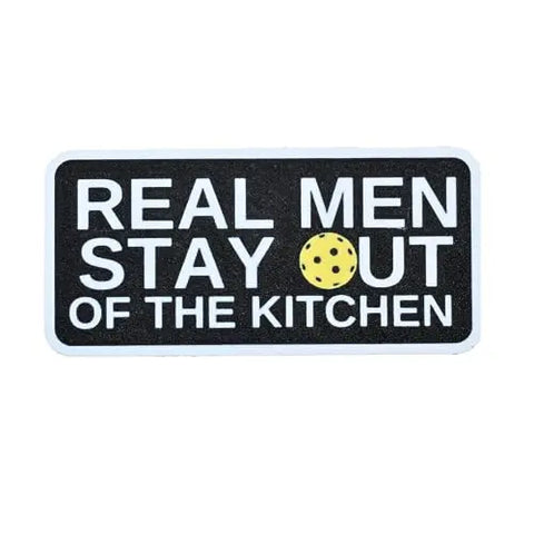 The Chatelet Manufacturing Pickleball Real Men Stay Out of the Kitchen Fridge Magnet features a black rectangle with white text and a yellow cookie for the O in OUT—a funny, USA-made gift for pickleball players or fans of quirky pickleball humor.