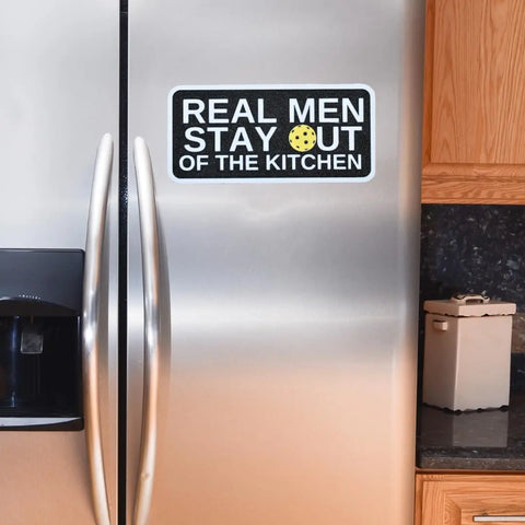 The Pickleball Real Men Stay Out of the Kitchen Fridge Magnet by Chatelet Manufacturing features a funny cookie “O” in OUT—a perfect USA-made gift for pickleball players to add humor to any kitchen, fridge, or metal surface.
