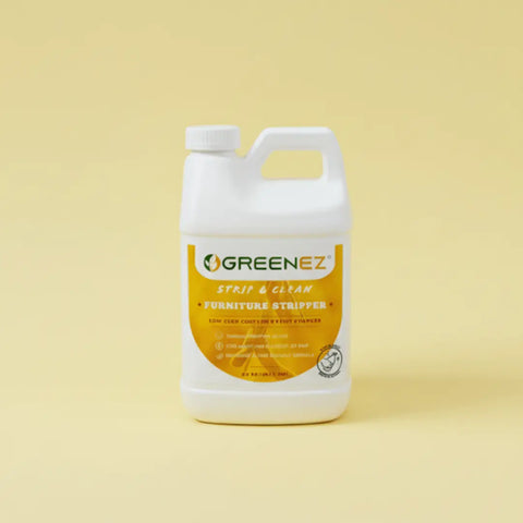 A white plastic container labeled GreenEZ® Furniture Stripper Gel 0.5 Gallon – Eco Friendly Paint Remover, Made in USA, features green and orange accents on a yellow and white label—perfect for restoring wood with its effective soy-based gel formula.