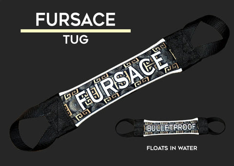 The Fursace Designer Tug Fire Hose Training Tug by Bulletproof Pet Products Inc is a stylish black and gold dog toy with black handles, labeled FURSACE TUG. Its durable, bulletproof, floats in water, and built for tough play.