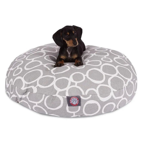 A small black and brown dog sits on the Majestic Pet Fusion Round Dog Bed, a large gray bed with white circles, a paw logo patch, and a washable, removable cover for easy cleaning.