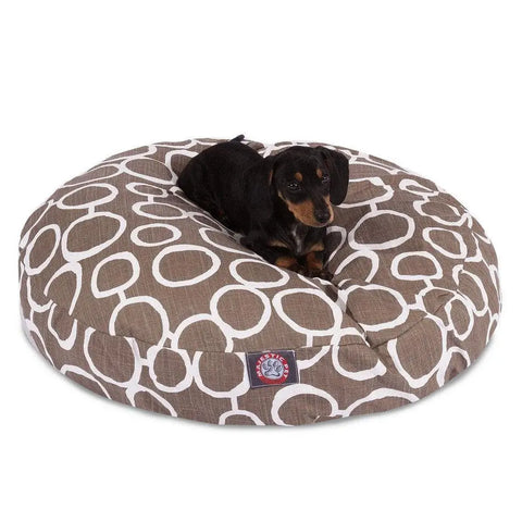 A small black and brown dachshund is lying on the Majestic Pet Fusion Round Dog Bed, which features a large, round shape, a brown color with a white circular pattern, and a washable, removable cover.
