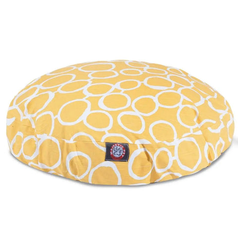The Fusion Round Dog Bed by Majestic Pet features a yellow design with a white circular pattern and a small patch logo on the front. Its removable, washable cover keeps it clean and fresh for your pet.