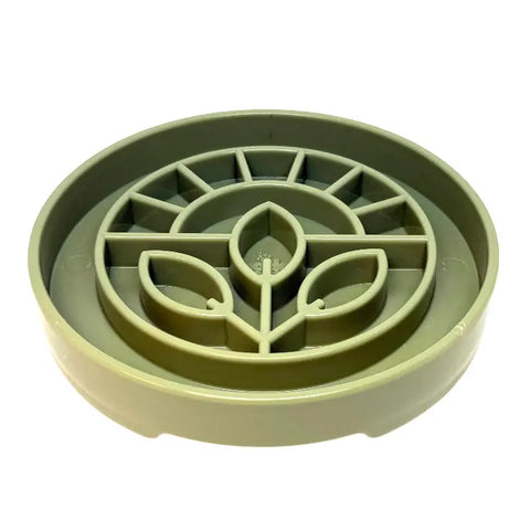 The SodaPup Garden Design ETray Enrichment Shallow Slow Feeder Dog Bowl is a round, light green plastic tray with leaf and geometric designs, ideal for slow feeding your dog or as a plant bottom watering tray.