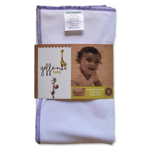 A folded white Geffenbaby Jersey Cloth Diaper Prefold (60% hemp/40% organic cotton) with purple trim, packaged with a label featuring a smiling baby, giraffe illustration, and text noting its handmade and reusable in the USA.