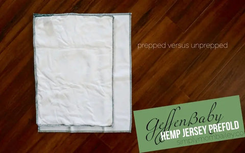 On a dark wooden floor are two white Geffenbaby Jersey Cloth Diaper Prefolds (60% hemp/40% organic cotton): one smaller and textured (prepped), the other larger and smoother (unprepped). Text: prepped vs. unprepped.