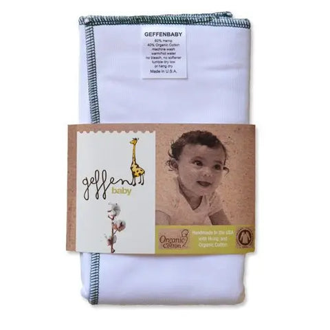 A white Geffenbaby Jersey Cloth Diaper Prefold (60% hemp/40% organic cotton) with green stitching is shown folded; packaging features a smiling baby, giraffe illustration, and states it’s handmade in the USA as a reusable diaper.