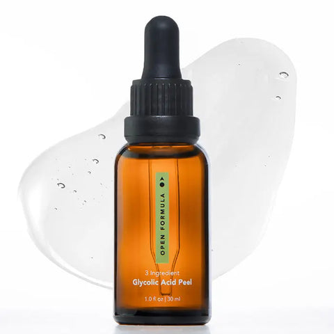 An amber glass dropper bottle with a black cap, labeled Open Formula Glycolic Acid Peel, is displayed in front of a clear gel smear on a white background. This peel from Open Formula exfoliates dead skin cells for radiant skin.