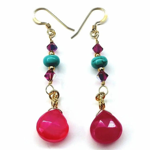 The Gold Filled Wire Wrapped Pink and Turquoise Gemstone Earrings by Alexa Martha Designs feature hot pink chalcedony teardrops, turquoise beads, and purple crystals in a dangle hook design.