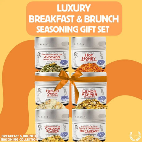 The Gustus Vitae Gourmet Breakfast Seasoning Set 6-Pack features all natural flavors, each tin labeled for brunch favorites like Avocado Toast and Hot Honey, elegantly arranged with a gold ribbon against a vibrant yellow backdrop. Made in USA.