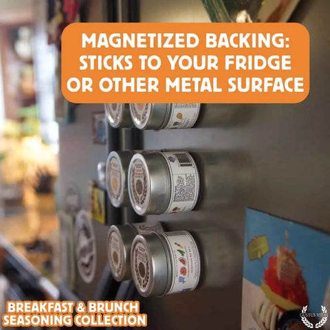 Six Gustus Vitae Gourmet Breakfast Seasoning tins are magnetically attached to a fridge, with text: MAGNETIZED BACKING: STICKS TO YOUR FRIDGE OR OTHER METAL SURFACE and ALL NATURAL SEASONINGS FOR BREAKFAST & BRUNCH—MADE IN USA.