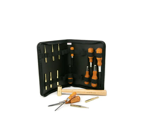 A black Nukaf case unzips to reveal the Grace USA Gun Care Tool Set, featuring chisels, punches, and a mallet with wooden handles and brass parts—each tool neatly held by elastic loops.