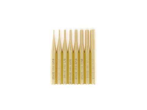 Eight gold-colored metal pin punches from the Grace USA Gun Care Tool Set in Nukaf Case are lined up vertically, each marked with different sizes and the GRACE USA brand—an essential for any gunsmith’s tool kit.