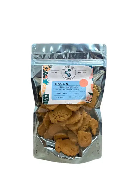 Dogtown Bakerys Bacon Treats come in a clear, resealable bag filled with small, light brown gluten-free dog treats flavored with uncured smoked bacon. The front label says Bacon along with brand details and leaf graphics.