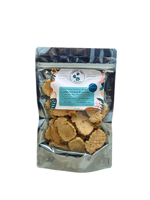 A clear, resealable pouch holds light brown, bone-shaped dog treats. The label reads Dogtown Bakery Chicken Cheese & Basil, features grain-free and nutritional info, and is accented with colorful abstract designs.