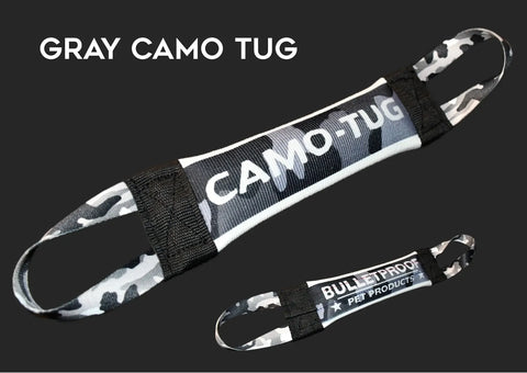 The Bulletproof Pet Products Inc Gray Camo Fire Hose Training Tug - Camo Series is a USA-made, durable pet toy with two handles and camo pattern, CAMO-TUG on the front and BULLETPROOF PET PRODUCTS on the back. Crafted from real fire hose for lasting use.