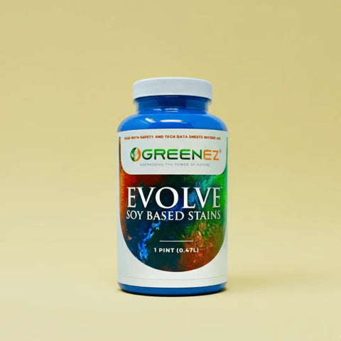 A blue plastic bottle of GreenEZ® Evolve Soy Wood Stains 1 Pint – Eco-Friendly Blend with a white cap, colorful label graphics, and volume info sits against a beige background. Made in USA.