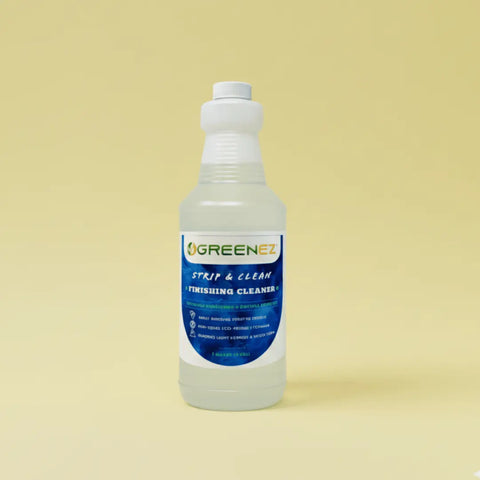 A 1-quart GreenEZ® Finishing Cleaner eco-friendly solution in a clear plastic bottle with a white cap and blue label stands upright against a plain yellow background. Made in the USA.
