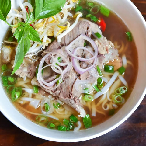 Enjoy a bowl of Vietnamese pho with rice noodles, beef, and fresh herbs, enhanced by Gustus Vitae’s Everything but the Food Truck Favorite Flavors Collection | Set of 4 for authentic street food taste.