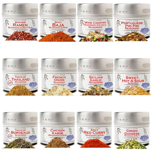 The Gustus Vitae Luxury World Seasonings – Gourmet 12 Pack Collection features twelve small tins, each with a unique flavor like Shichimi Ramen, Baja, Wine Country, and Portuguese Piri Piri neatly arranged in three rows.