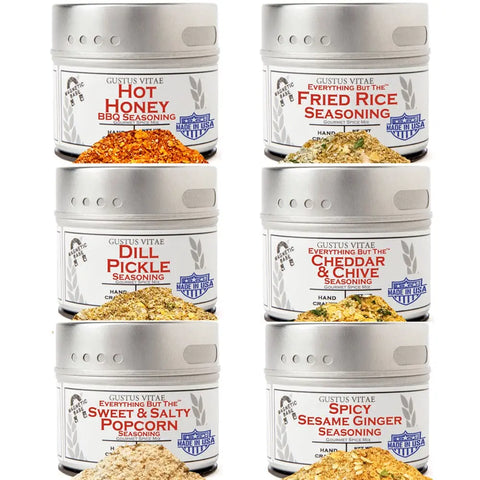 The Gustus Vitae Six Elements of Flavor Seasoning Set features six artisanal blends—Hot Honey BBQ, Fried Rice, Dill Pickle, Cheddar & Chive, Sweet & Salty Popcorn, and Spicy Sesame Ginger—each in a tin with a window for easy viewing.