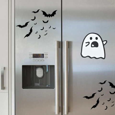 A silver refrigerator featuring Chatelet Manufacturing’s Halloween Decorative Fridge Magnets—perfect spooky party decor made in the USA—displays black bats and a large cartoon ghost for a playful Halloween look.