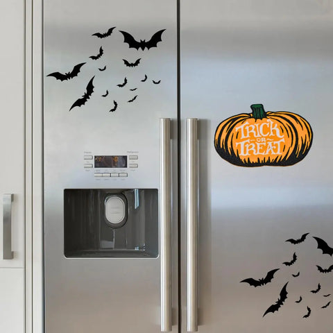A silver refrigerator decorated with Chatelet Manufacturings Halloween Decorative Fridge Magnets, featuring spooky designs and a Trick or Treat pumpkin sticker—perfect festive decor for your Halloween party. Made in the USA.