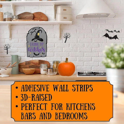 A kitchen decorated for Halloween with a pumpkin, jars, bats and tree decals, plus Chatelet Manufacturing’s Drink Up Witches 9.5x6.5 wall sign—adhesive strips make it perfect party decor for kitchens, bars, or bedrooms. Made in USA.