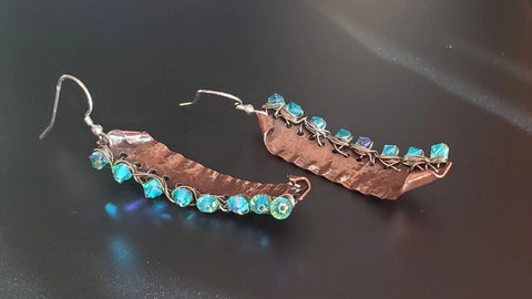 Blue Green Hammered Copper Bar Crystal Earrings by Alexa Martha Designs, featuring turquoise beads woven along one edge, displayed on a black surface.