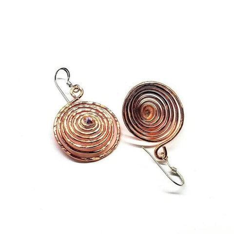 Crystal Embedded Copper Spiral Hoop Earrings by Alexa Martha Designs, featuring handmade concentric spiral patterns and simple metal hooks, displayed on a white background.