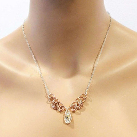 The Copper Wire Sculpted Angel in Flight Necklace by Alexa Martha Designs is showcased elegantly on a mannequin.