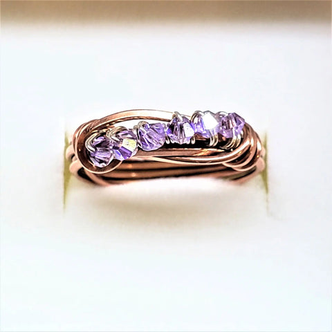 The Alexa Martha Designs Wire Wrapped Copper Crystal Birthstone Bling Ring features five small purple crystals in a row on rose gold, shown against a white background.