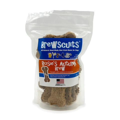Rosies Autumn Brew by Brewscuits is a clear bag of bone-shaped dog treats made with pumpkin, cranberries, and cinnamon. The blue and orange label highlights theyre all-natural, handmade, and promote digestive health.