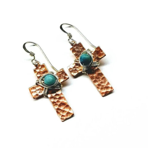 Hammered Copper Cross Earrings With Turquoise Beads by Alexa Martha Designs, these handcrafted earrings feature wire-wrapped turquoise accents and are beautifully displayed on a white background.