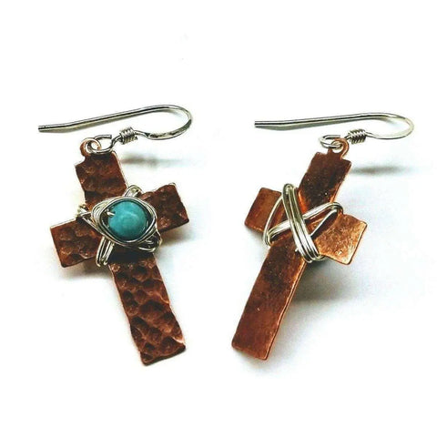 The Hammered Copper Cross Earrings With Turquoise Beads by Alexa Martha Designs feature one earring with a turquoise jasper bead and silver wire, and the other with just silver wire—unique handcrafted statement earrings.