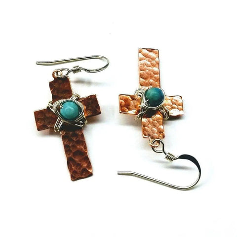 Hammered Copper Cross Earrings With Turquoise Beads by Alexa Martha Designs, featuring handcrafted hammered copper crosses accented with wire-wrapped turquoise jasper beads, displayed on a white background.