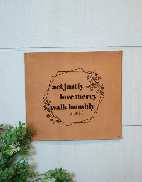 The Urban Southern Act Justly Leather Sign features a tan leather design with floral accents and the quote act justly, love mercy, walk humbly MICAH 6:8, making it a stylish wall decor piece.