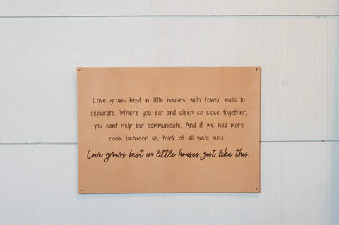 The Urban Southern Love Grows Best Leather Sign is a tan engraved piece that reads: Love grows best in little houses, with fewer walls to separate... Perfect rustic home decor for any space.