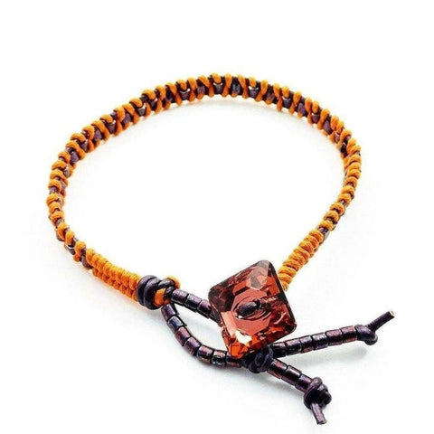 The Orange Purple Leather Beaded Rattlesnake Tail Weave Bracelet by Alexa Martha Designs features a handmade woven band and adjustable brown bead ends.
