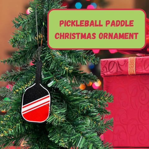 A Christmas tree features the Chatelet Manufacturing Pickleball Paddle Christmas Ornament and a red gift. Above, a sign reads: Perfect holiday ornament for pickleball fans—made in the USA.