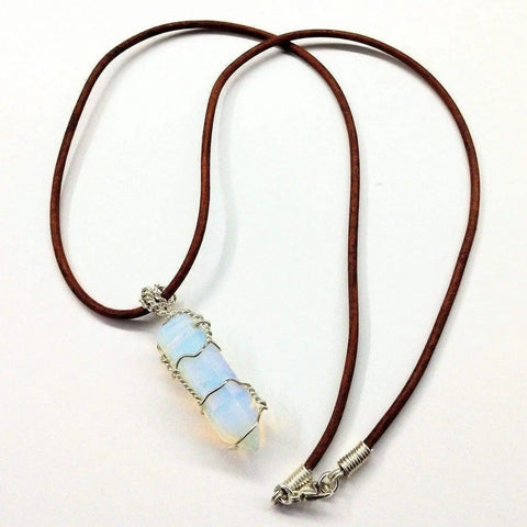 The Alexa Martha Designs Silver Wire Wrapped Gemstone Crystal Point Pendant showcases a pointed opalite crystal on a brown leather necklace, accented with elegant sterling silver wire and displayed on a white background.