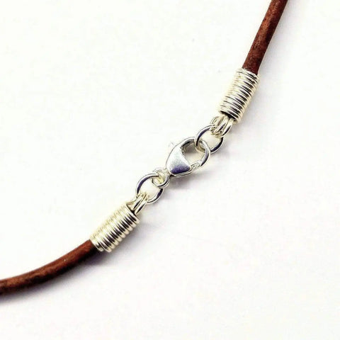 A brown leather necklace with a silver lobster clasp and coil end caps by Alexa Martha Designs, shown on white—perfect for pairing with your Silver Wire Wrapped Gemstone Crystal Point Pendant.