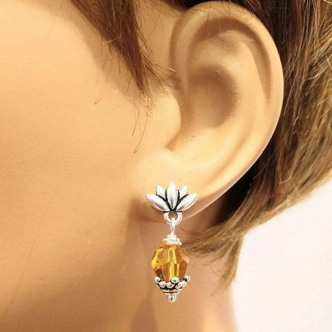 A mannequin with short brown hair displays Alexa Martha Designs Sterling Silver Crystal Pineapple Studded Earrings.