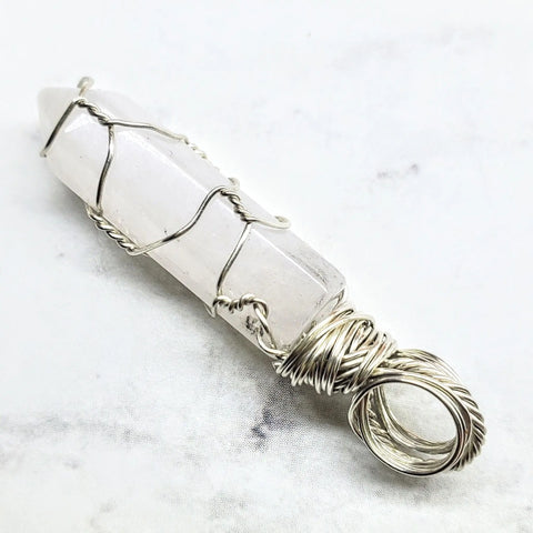 The Alexa Martha Designs Sterling Silver Messy Wire Wrap Gemstone Pointed Crystal Pendant features a clear quartz crystal wrapped in sterling silver with a top loop, shown on a white background.