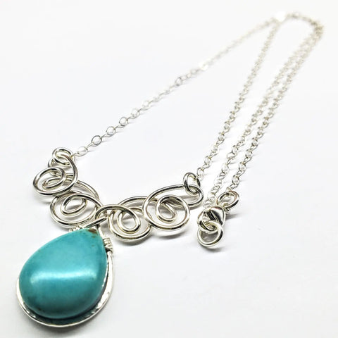 The Alexa Martha Designs As Seen on TV Turquoise Drop Sterling Silver Wire Wrapped Necklace features a large teardrop pendant, intricately handmade and beautifully displayed on a white background—a stunning Montana-made piece.